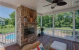 Screen porch with fireplace off kitchen